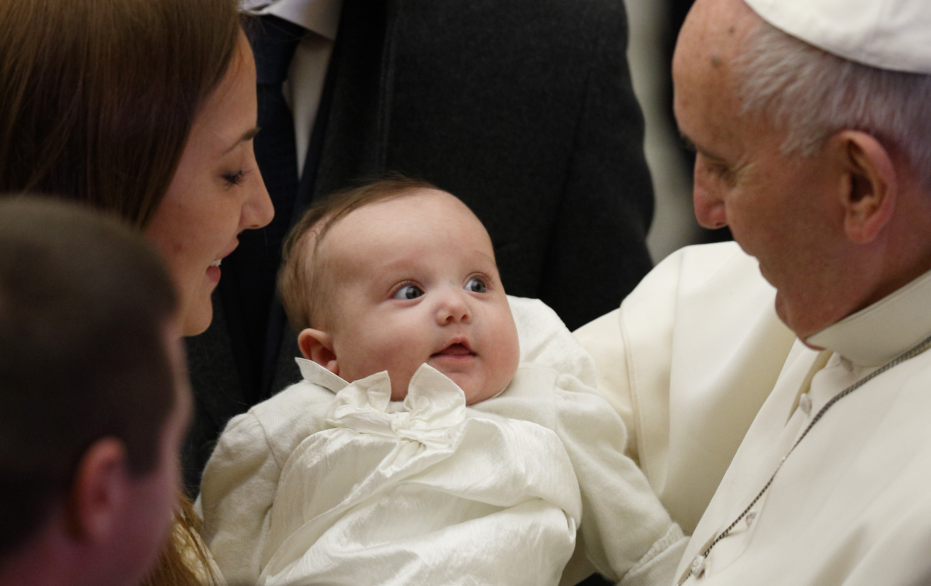 Pope Francis greets a baby during his general audience in Paul VI hall at the Vatican Jan. 7. (CNS photo/Paul Haring) See POPE-AUDIENCE Jan. 7, 2015.