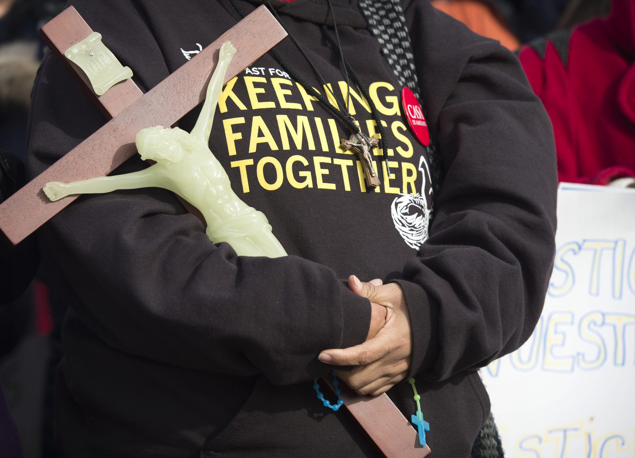A woman holds a crucifix during a rally sponsored by immigration advocates Jan. 15 outside the Supreme Court in Washington. (CNS photo/Michael Reynolds, EPA) See GSR-SISTERS-IMMIGRATION March 17, 2016.