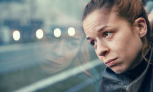 A woman in streetcar alone and annoyed