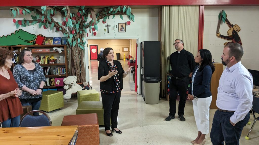 Jennifer Carr Allmon, executive director of the TCCB, speaking to Rep. Joe Moody and Rep. Claudia Ordaz at Most Holy Trinity School in El Paso.